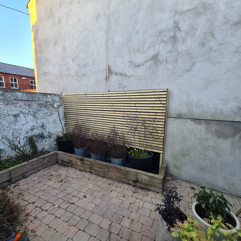 Slatted timber screen built to hide the bin storage area