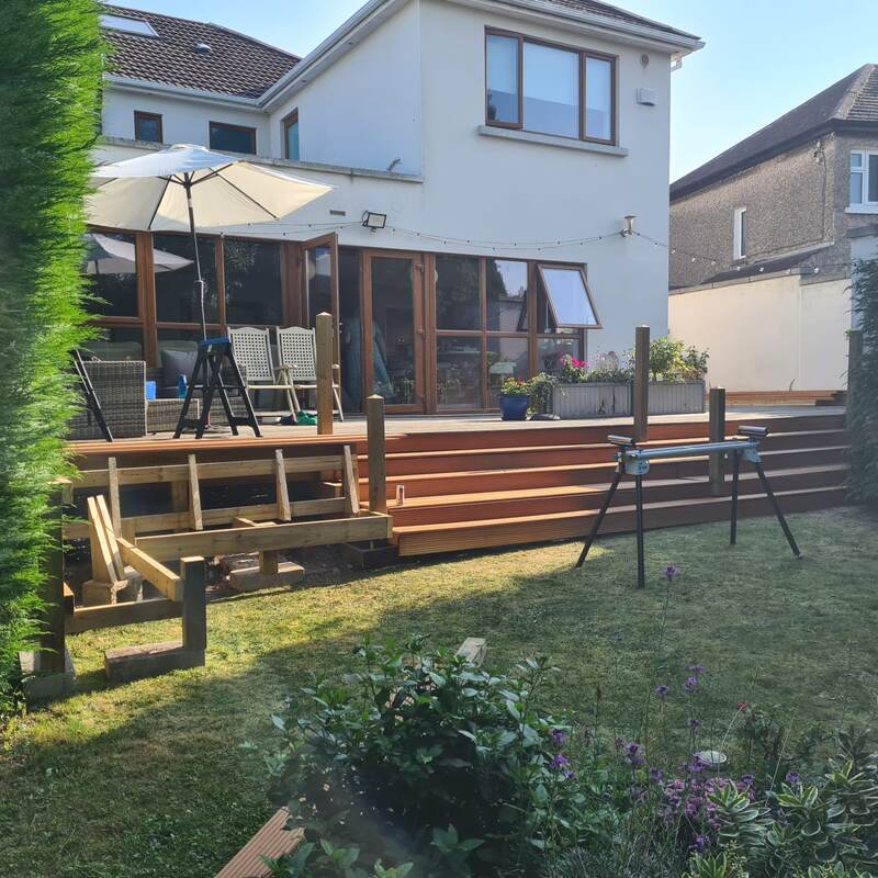 Deck mid-build with new joists and boards partly laid