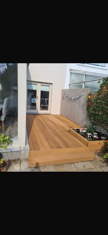 Wider view of the finished balcony decking with steps and planter