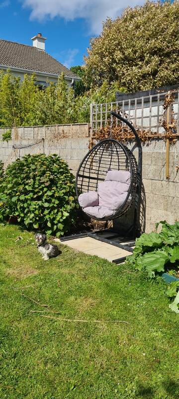 Same corner finished with a paved base and hanging egg chair