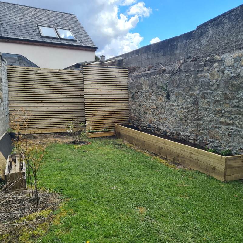 Slatted timber screen and raised bed built