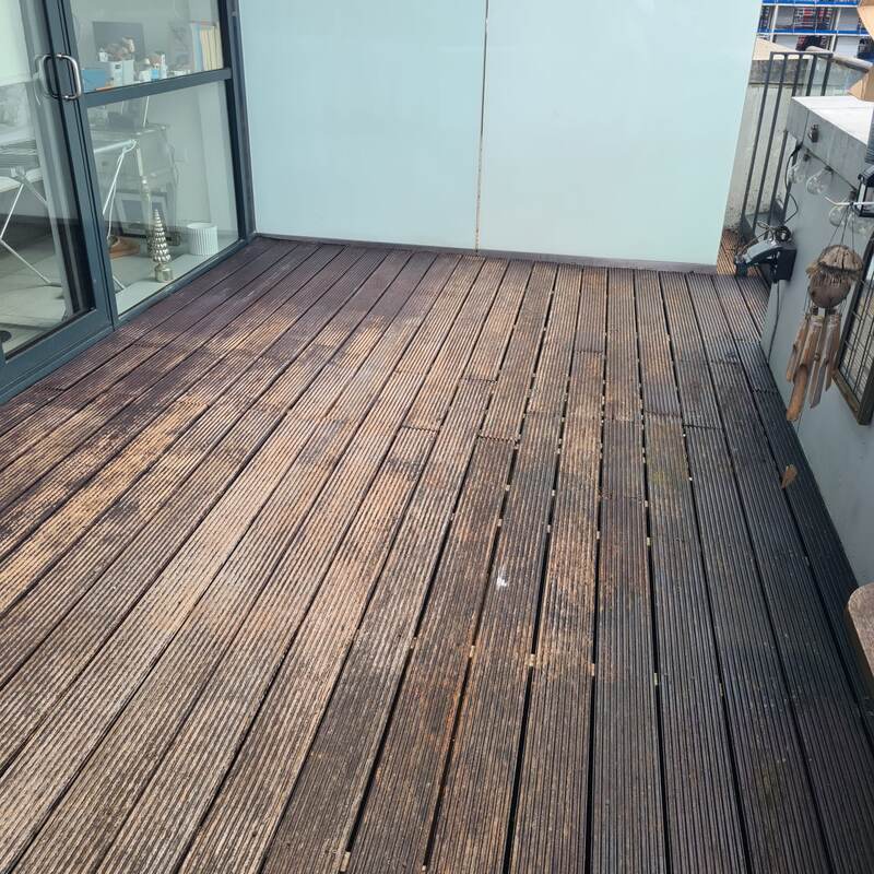 Weathered brown balcony decking before restoration