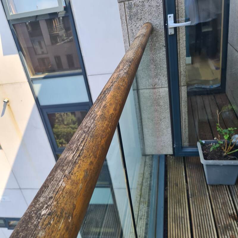 Weathered, peeling timber handrail before restoration
