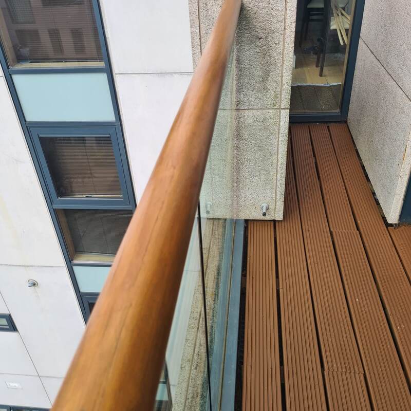 Same handrail refinished with a clean golden stain