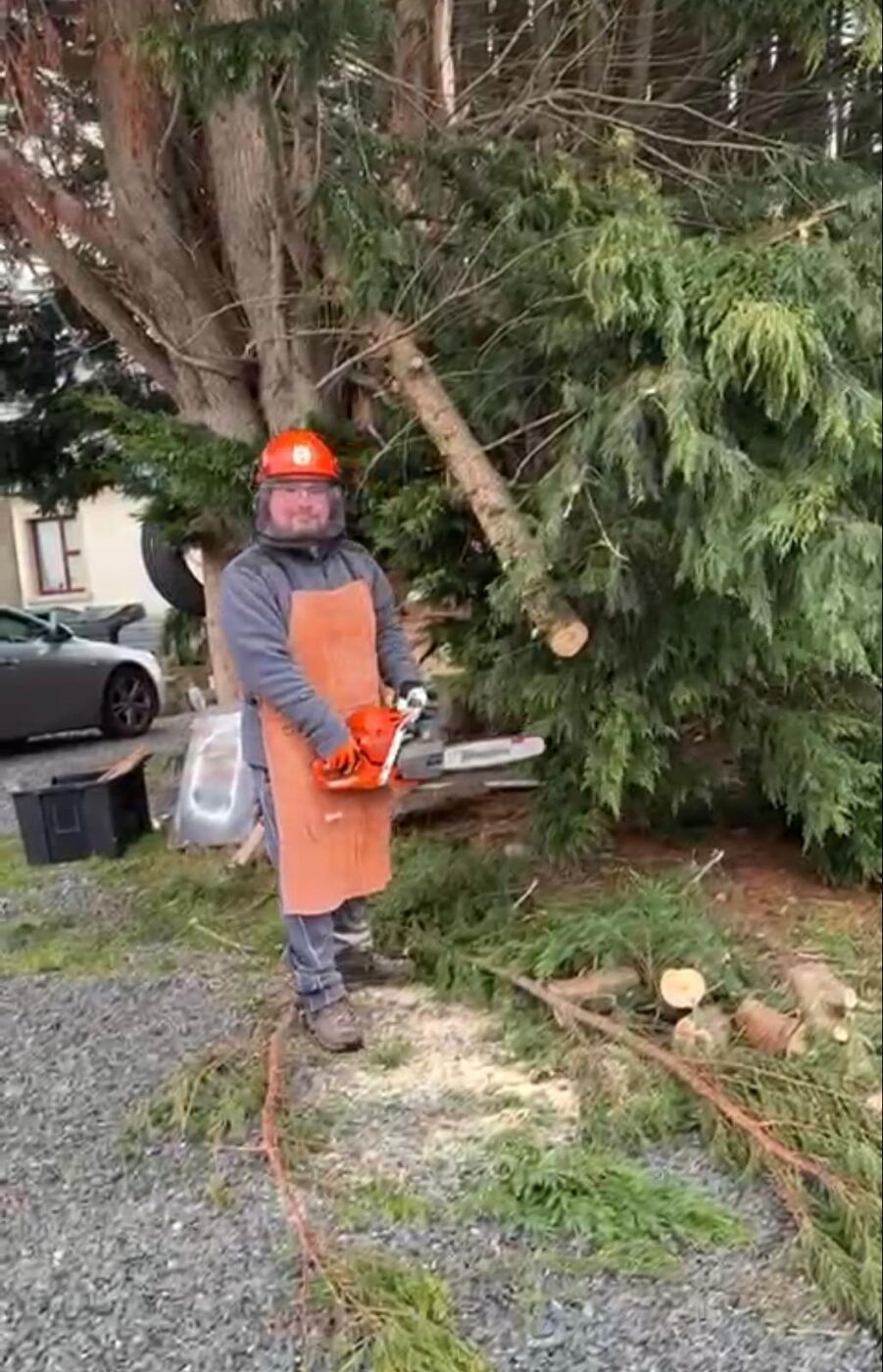 Chris in full safety gear with a chainsaw, on site