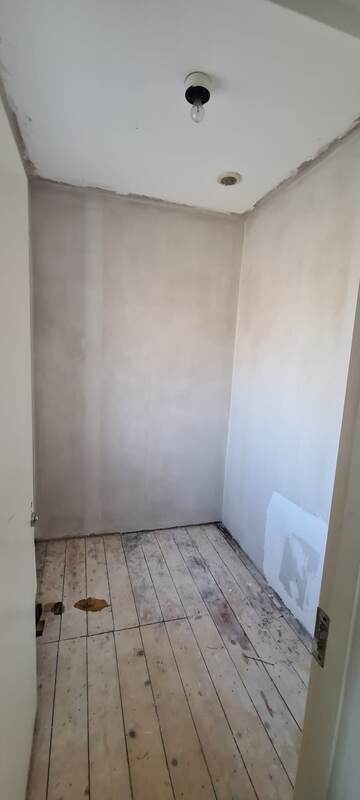 Plain box room before conversion, bare plaster and floorboards